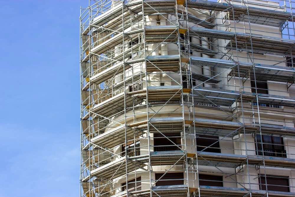 Restoration of an old building facade moldings, arched windows.